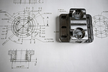 Wall Mural - Precision-machined metal component lying on its technical drawing, showcasing accuracy and engineering