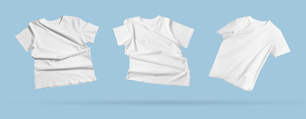 Wall Mural - White t-shirts in air on light blue background