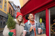 © ReeldealHD images - Friends happily Christmas shopping walking down a street