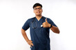 © ArvStd - Smiling upbeat, confident male asian nurse in scrubs have all under control, show thumbs-up in approval, guarantee quality of service in clinic