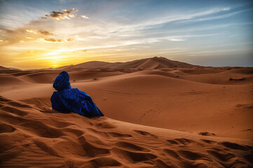 Berber man at sunset in the Sahara desert of Merzouga, Morocco., North Africa