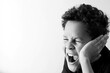 © herlanzer - deaf child with no hearing aid hard of hearing deafness covering his ears with people stock image stock photo