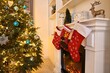 © New Africa - Fireplace with stockings and Christmas tree indoors
