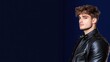 © Edo - A stylish young man in a leather jacket poses against a dark backdrop.