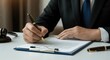 © Konstiantyn Zap - Male adult signing legal document in office setting