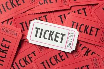 Single white vintage admission ticket among red tickets