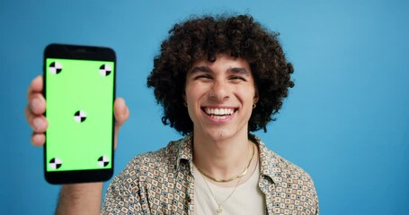 Wall Mural - man, phone and green screen in studio with face, smile or excited with mockup space by blue backgrou