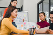 © PRIME STOCK LAB - Team discussing charts and data in modern office space