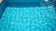 © RABBI - High-Angle View of Sparkling Light Blue Swimming Pool Water with Light Reflections, Crystal Clear, High-Resolution Photography