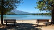 Serene Lakeside Scene, Two Benches on Sandy Shore, Mountains in Background - Italy