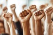 © Dhoku  Studio - Close-up of Raised Fists in a Crowd of People