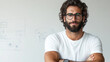 © VERTEX SPACE - Confident man with glasses and beard wearing white t shirt, standing with arms crossed in modern office environment, exuding professionalism and approachability