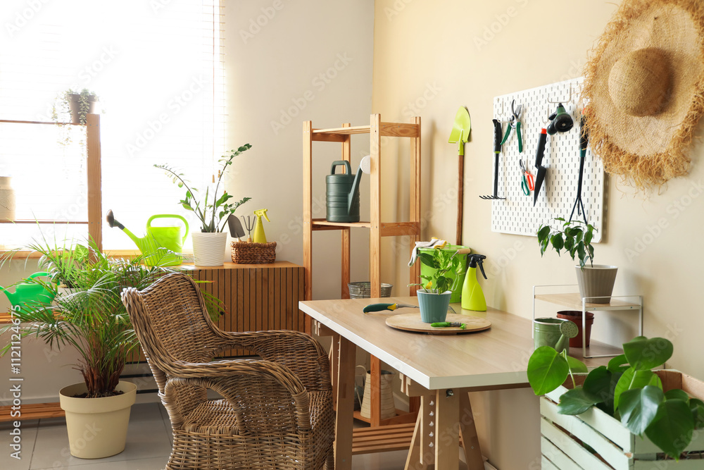 Interior of workshop with gardening tools, pegboard and workplace