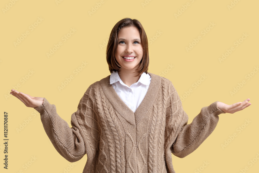 Beautiful young woman meditating on yellow background