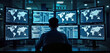 © Pete - Person works in global security operation center. Multiple monitors display information related to global activity. Person focused on managing, overseeing complex systems. Environment control center