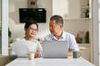 © imtmphoto - senior asian couple making financial plan using laptop computer