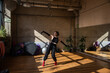 © Дмитро Петрина - A girl dances a contemporary dance in a sunlit studio