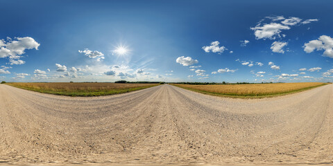 Wall Mural - blue sky hdri 360 panorama with awesome clouds on gravel road among fields in spring day in equirect