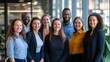 © FC - Diverse team members smiling after a successful meeting in a glass-walled office