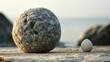 © Galib - A large and a small, round stone on a rocky surface.