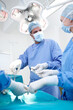 © peopleimages.com - Surgery, team and doctors in operating room with medical tools, healthcare and expert treatment at hospital. Men, women and surgeon in theater together with ppe equipment, support and emergency care