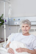 © peopleimages.com - Healthcare, senior woman and portrait in hospital bed for surgery recovery, rehabilitation and medical treatment. Elderly, person and smile with IV fluid for medication, health nutrients and healing