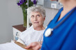 © peopleimages.com - Doctor, clipboard and senior patient in hospital bed for healthcare results, surgery update and recovery. Elderly woman, surgeon or health support for diagnosis, illness progress and rehabilitation
