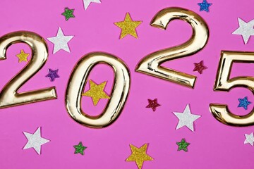 Wall Mural - golden numbers 2025 two thousand twenty five new year with colorful stars confetti on pink background