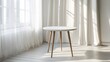 © horizon - Modern white table with wooden legs bathes in natural window light, casting geometric shadows across clean interior with sheer curtains and Scandinavian design elements.