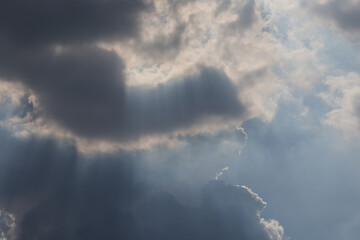 Wall Mural - the sky is cloudy and the sun is shining through the clouds