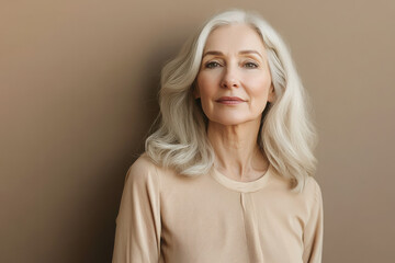 Wall Mural - A portrait of a mature woman with long, silver hair, showcasing confidence and grace.