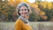 © Nany - A mature adult standing outdoors, with a beautiful natural backdrop and a warm smile