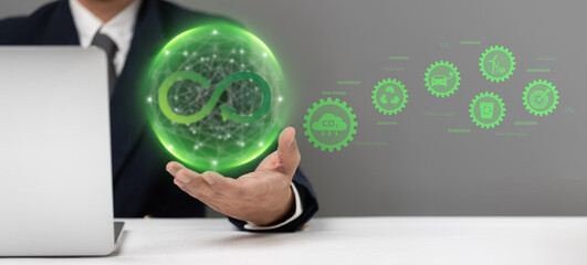 Wall Mural - Businessman holding a green sustainability icon representing circular economy, eco-friendliness, and corporate responsibility. Ideal for ESG reports, green energy promotions