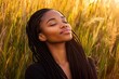 © Espresso - A serene Black woman with long braids enjoys the golden glow of a sunset in a field of tall grass.