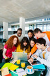 © Xavier Lorenzo - Vertical shot of young group of teenage student friends studying at high school campus. Education lifestyle and teamwork concept
