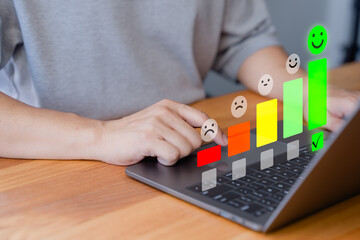 Fototapete - Customer using a laptop select a happy face icon from a feedback scale with five emoji option, symbolizing customer satisfaction, review, and positive user experience in an online feedback system.