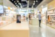 © Gophotograph - Customers exploring a variety of mobile phones in an electronic retail space.
