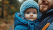 © jiraporn - Father and Baby in Warm Winter Clothing in Nature Setting