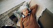 © peopleimages.com - Above, sleeping and tired with old woman on sofa with dog for break, dreaming and relax. Fatigue, wellness and animal care with senior person in living room at home for retirement, comfort and rest