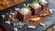 © Marry93 - Chocolate mousse topped with shredded coconut and a sprinkle of cinnamon, served on a rustic slate board