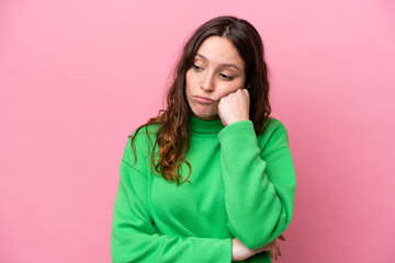 Wall Mural - Young caucasian woman isolated on pink background with tired and bored expression