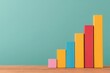 © Aurora - A simple, colorful bar chart with ascending blocks on a wooden desk against a pastel green background, symbolizing progress and success.