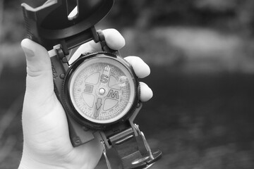 Wall Mural - round compass in hand on abstract background
