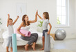 © Studio Romantic - Happy sporty family, mother and kids with yoga mats ready to exercise in fitness center smiling slim sporty girl, boy, woman wearing sportswear waiting for training at home active leisure joy weekend
