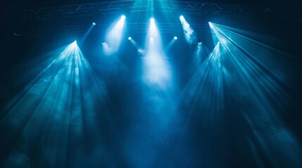 Wall Mural - an empty stage glows with blue and white lights, casting shadows and a misty feel. it evokes energy 