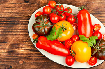 Wall Mural - Ripe tomatoes on rustic wooden background.