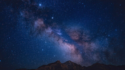 Wall Mural - breathtaking view of night sky dominated by dense star cluster, luminous band stretched across, coun