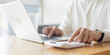 © chinnarach - close up employee man hand press on calculator to check and counting about financial report and profit quarter in office room at marketing department for business and lifestyle concept