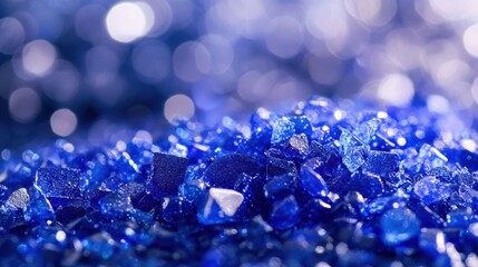Sapphire glitter texture with droplets and soft bokeh background