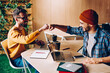 © BullRun - Prosperous male it developers clinking fists in sign of agrement cooperating on common startup project, young hipster guys greeting while meeting in coworking space for working creative together